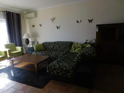 a living room with a couch and a table at Vista da Atlantica in Luz