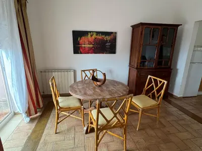 a dining room table with chairs and a wooden cabinet at Dream Executive Apartments in Luz
