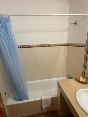 a bathroom with a bath tub and a sink at Dream Executive Apartments in Luz
