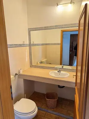 a bathroom with a sink and a toilet and a mirror at Dream Executive Apartments in Luz