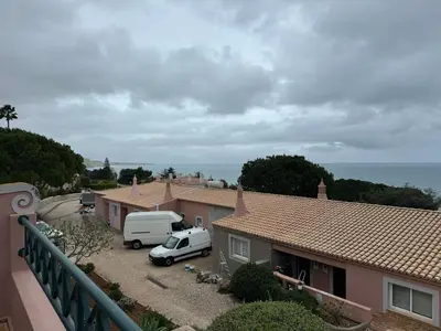 a white van parked in a parking lot next to houses at Dream Executive Apartments in Luz