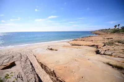 a sandy beach with the ocean in the background at Luz Beach Ocean Front Apartment in Luz