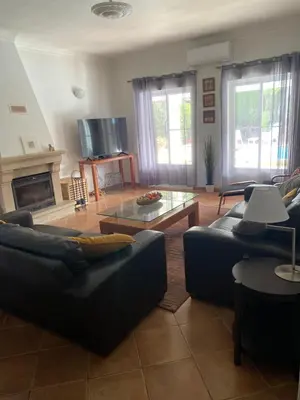 a living room with a couch and a table at Holiday villa with pool near the ocean, fast internet, Aljezur in Aljezur