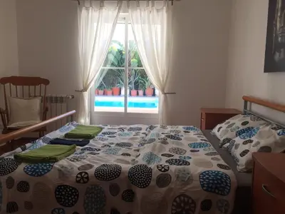 a bedroom with a bed and a window at Holiday villa with pool near the ocean, fast internet, Aljezur in Aljezur