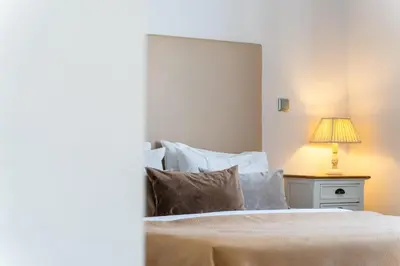 a bedroom with a bed with a lamp on a table at Golden escape in Funchal in Funchal