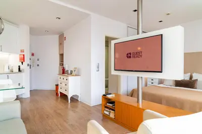 a living room with a flat screen tv in a room at Golden escape in Funchal in Funchal