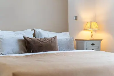 a bedroom with a bed with a lamp on a night stand at Golden escape in Funchal in Funchal