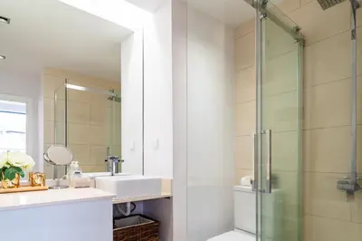 a bathroom with a sink and a glass shower at Golden escape in Funchal in Funchal