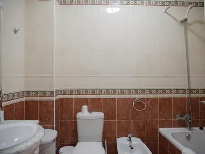 a bathroom with a toilet and a sink and a tub at Large Penthouse Near Porto de Mos Beach With Magnificent Views In Lagos in Lagos
