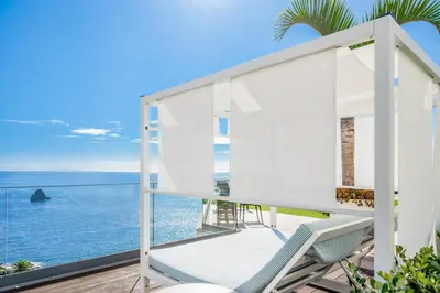 a house with a view of the ocean at Hotel Baia Azul in Funchal