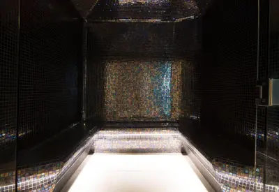 a black room with a shower with a window at Hotel Baia Azul in Funchal