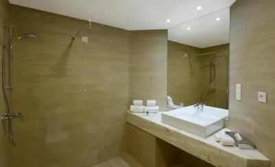 a bathroom with a sink and a shower at Hotel Baia Azul in Funchal