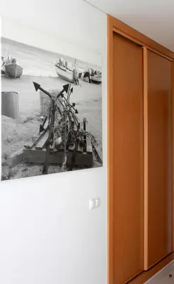 a wall with a picture of a beach with boats at Casa Praia Mar in Salema