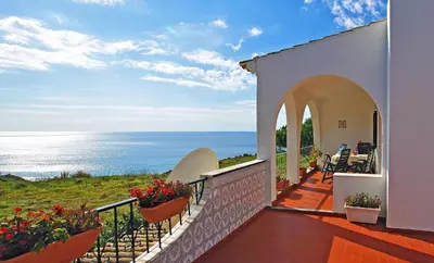 a balcony of a house with a view of the ocean at VIVENDA JOHANNA in Lagos