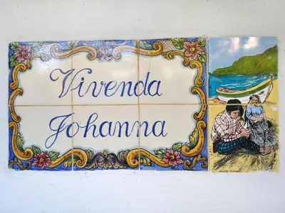 a sign on a wall with a picture of a couple at VIVENDA JOHANNA in Lagos