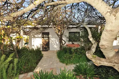a white house with a tree in front of it at VIVENDA JOHANNA in Lagos
