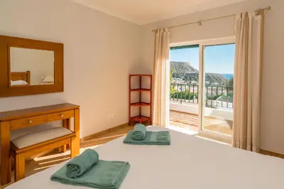 a bedroom with a bed with a mirror and a window at Luz Top Views in Lagos