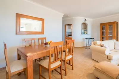 a dining room and living room with a table and chairs at Luz Top Views in Lagos