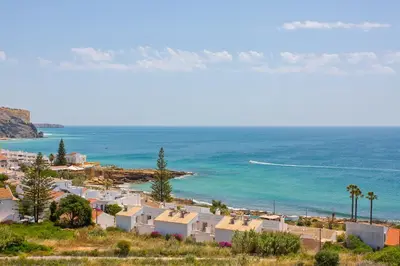 a view of a beach with houses and the ocean at Luz Top Views in Lagos