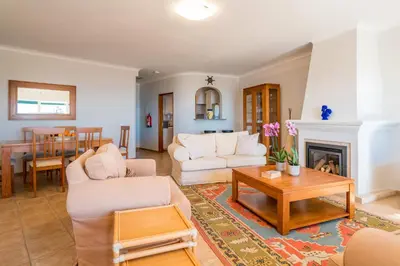 a living room with white furniture and a fireplace at Luz Top Views in Lagos