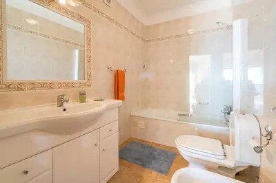a bathroom with a sink and a toilet and a tub at Luz Top Views in Lagos