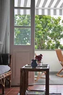 a table with a vase on it next to a door at OLD TOWN PENTHOUSE - Barreirinha in Funchal