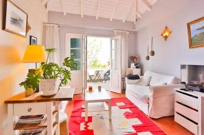 a living room with a white couch and a table at OLD TOWN PENTHOUSE - Barreirinha in Funchal