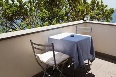 a table and two chairs with a blue table cloth on a balcony at OLD TOWN PENTHOUSE - Barreirinha in Funchal