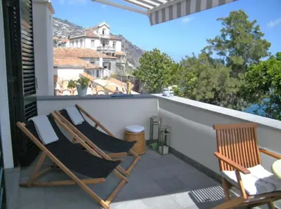 two chairs sitting on the balcony of a house at OLD TOWN PENTHOUSE - Barreirinha in Funchal