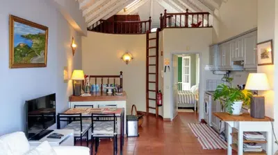 a living room with a spiral staircase in a house at OLD TOWN PENTHOUSE - Barreirinha in Funchal