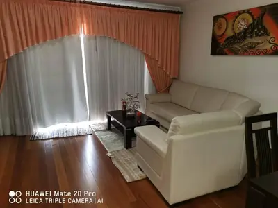 a living room with a couch and a table at Andrade Blue in Caniço