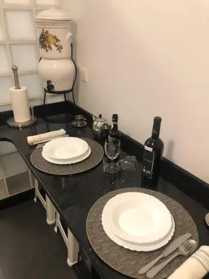a black counter with two white plates and wine bottles at Andrade Blue in Caniço