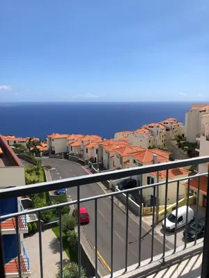 a view from a balcony of a city and the ocean at Andrade Blue in Caniço