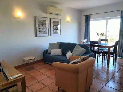 a living room with a blue couch and a table at Vilita in Lagos