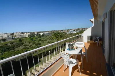 a balcony with a table and chairs and the ocean at Vilita in Lagos