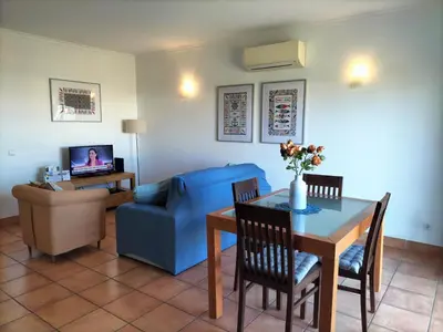 a living room with a table and a blue couch at Vilita in Lagos