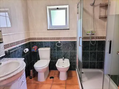 a bathroom with a toilet and a sink and a shower at Vilita in Lagos