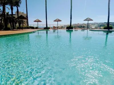 a large pool of blue water with umbrellas in it at Vilita in Lagos