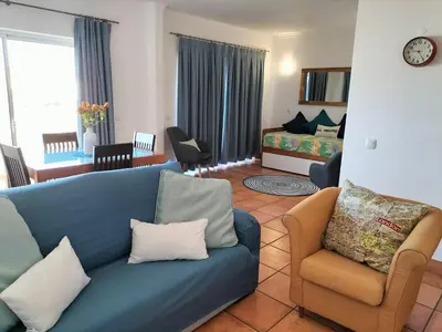 a living room with a blue couch and chairs at Vilita in Lagos