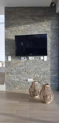 a living room with a table and a mirror at Sunrise Villa in Sagres