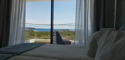 two chairs and a coffee table in a room at Sunrise Villa in Sagres