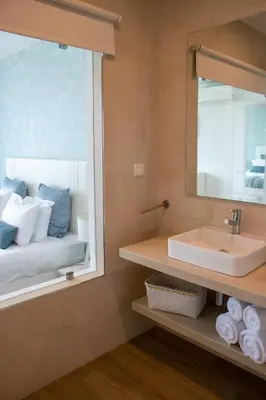 a mirror reflection of a bed in a bedroom at Sunrise Villa in Sagres