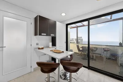 a living room with a couch with a view of the ocean at Two Bedroom Apartment with Balcony and Gorgeous view over the Atlantic in Funchal
