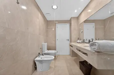 a bathroom with two sinks and a large mirror at Two Bedroom Apartment with Balcony and Gorgeous view over the Atlantic in Funchal