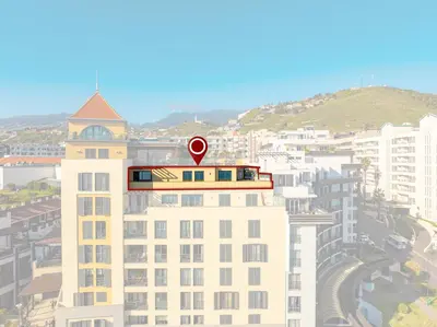 a balcony with a wooden table and bench on a building at Two Bedroom Apartment with Balcony and Gorgeous view over the Atlantic in Funchal