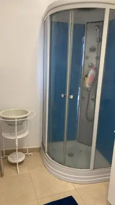 a glass shower in a room with a table at SLICE OF PONTA DO SOL- GROUND FLOOR- SEA VIEW in Ponta do Sol