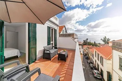 two beds in a white room with a window at Calçada do Pico I by An Island Apart in Funchal