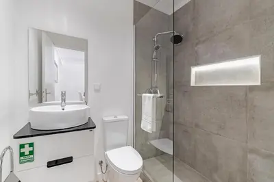 a white kitchen with white cabinets and a sink at Calçada do Pico I by An Island Apart in Funchal