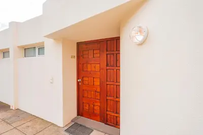 a wooden door with a clock on the side of a building at FLH Funchal Ocean View with Pool in Funchal