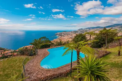 a swimming pool with the ocean in the background at FLH Funchal Ocean View with Pool in Funchal